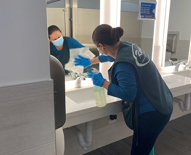 Rangel Janitorial crew member sanitizing a commercial restroom